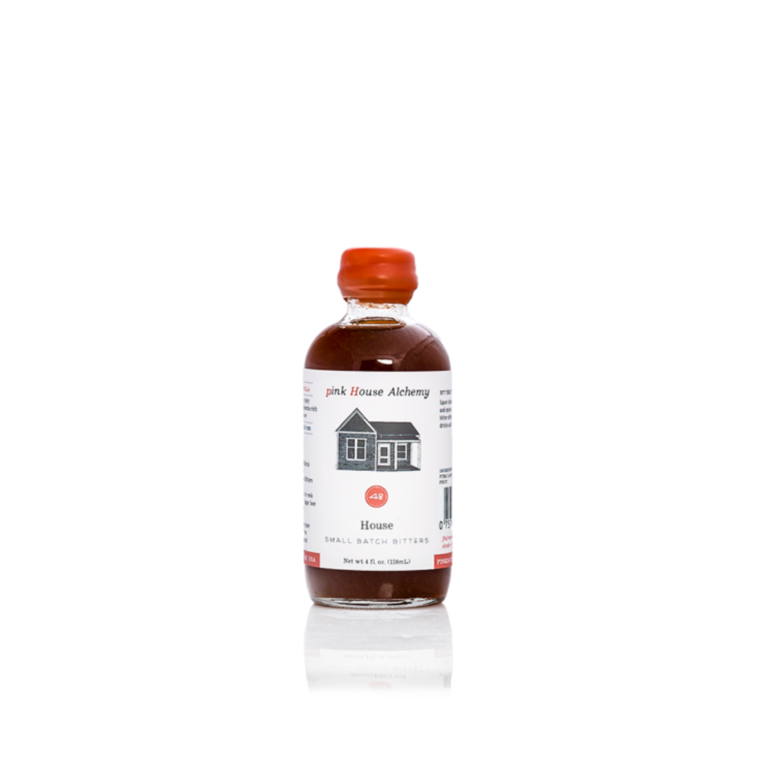 Bottle of 'Pink House Alchemy' bitters on a white background