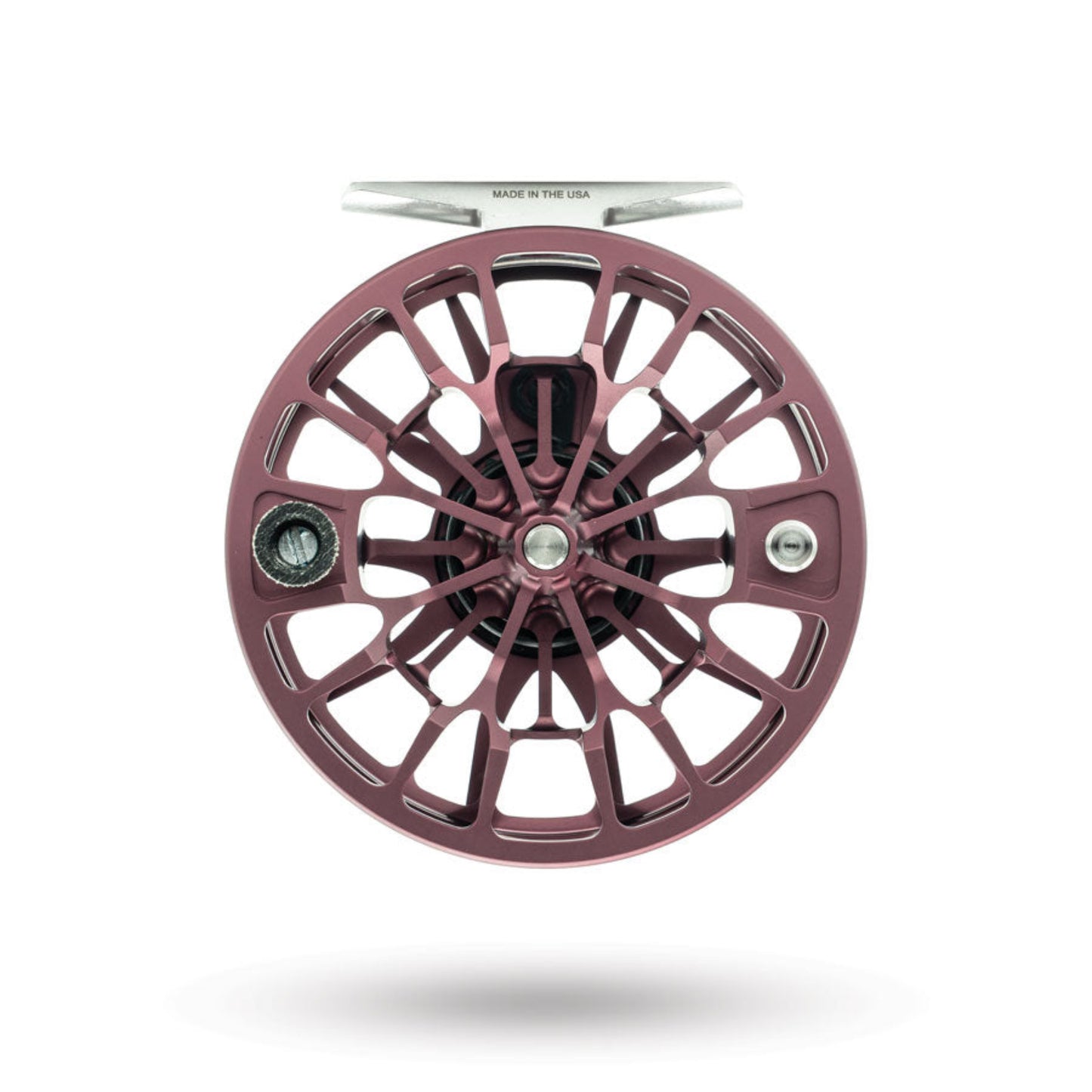 Metallic purple fly fishing reel on a white background