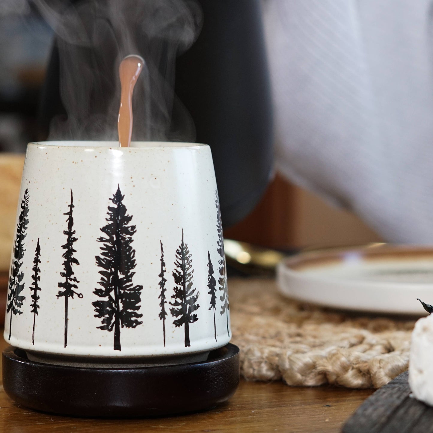 Ceramic diffuser with tree designs on a wooden table