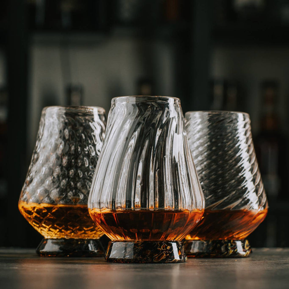 
                  
                    These exquisite glasses are hand-blown right here in the Pacific Northwest. Each of the three glasses is crafted using a unique mold, resulting in their distinct styles. Sold individually, you can assemble your own set.

The Hand-Blown Neat Pour Glass is meticulously crafted to amplify the aromatic notes of your selected spirit, ensuring an exquisite and immersive drinking experience. It is an ideal choice for a diverse range of beverages, including smooth scotch and aged tequila, as well as any other premi
                  
                