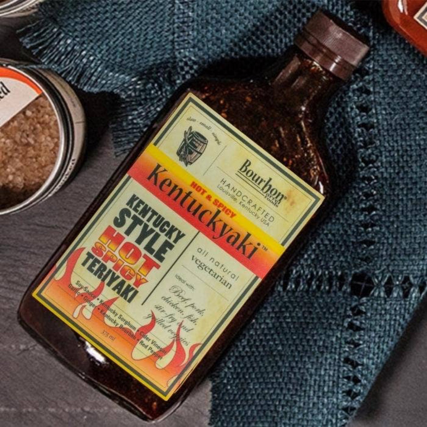 Bottle of Kentucky Style Hot Spicy Teriyaki sauce on a textured surface