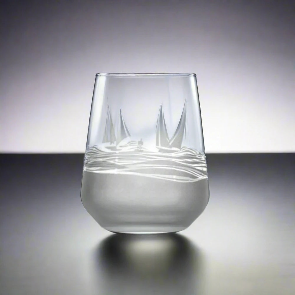 
                  
                    Experience the charm of the sea with every sip from our Regatta 15.75oz Stemless Wine Glass. This beautifully crafted glass features a sand-etched design of stylized sailboats, adding a touch of nautical elegance to your wine tasting experience. The stemless design ensures a comfortable grip, while the deep bowl allows you to appreciate the aroma of your favorite wines. Perfect for wine enthusiasts and nautical aficionados alike.
                  
                
