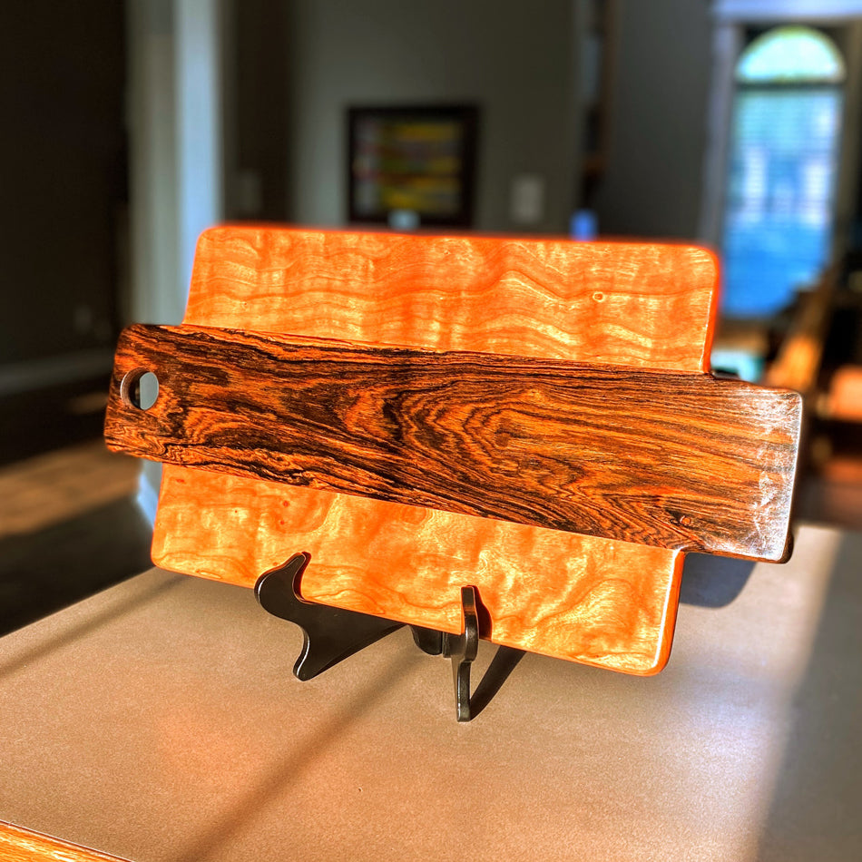 This Charcuterie Board has been expertly handcrafted with Bocote and Curly Cherry, measuring 21" L x 1" D x 11 1/4" W. It is further finished with the Sutherland Welles Ltd.® Botanical Polymerized Tung Oil High Lustre and Bowl & Board™.