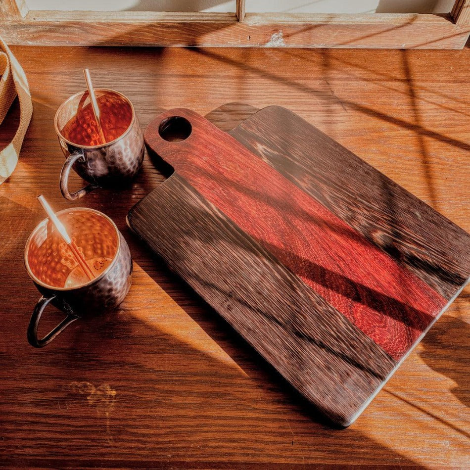 
                  
                    This Charcuterie Board is crafted from Padauk and Wenge for a beautiful yet durable cutting surface. The 16-inch board (including handle) delivers ample space to hold meats, cheeses, fruits, and other appetizers, while the 1-inch thickness offers durable rigidity. A Millie's All-Purpose Penetrating Tung Oil finish seals to further reinforce the board's strength and longevity.
                  
                