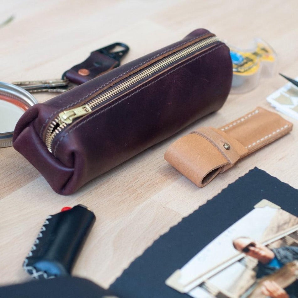 
                  
                    Experience luxury and reliability with High Line Leather Pouch. Crafted with premium-grade leather and robust brass zippers, this pouch comes in three sizes to suit your lifestyle. Whether for the office, an outdoor adventure, or traveling the globe, this pouch will keep your things protected and stylishly stored.
                  
                