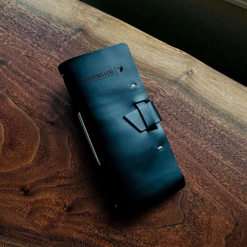 
                  
                    Leather Hunting Journal - Early season or better yet preseason or scouting, our Leather Hunting Journal is a great tool for keeping up with key observations, weather conditions, morning or evening and most importantly, your first hunt with your son or daughter.  Designed to be used on any type of hunt, this leather journal is a outdoors enthusiast partner, soon to be filled with memories of a lifetime.   3.75" x 1" x 8" Includes 96 printed rough-cut cream-colored pages
                  
                