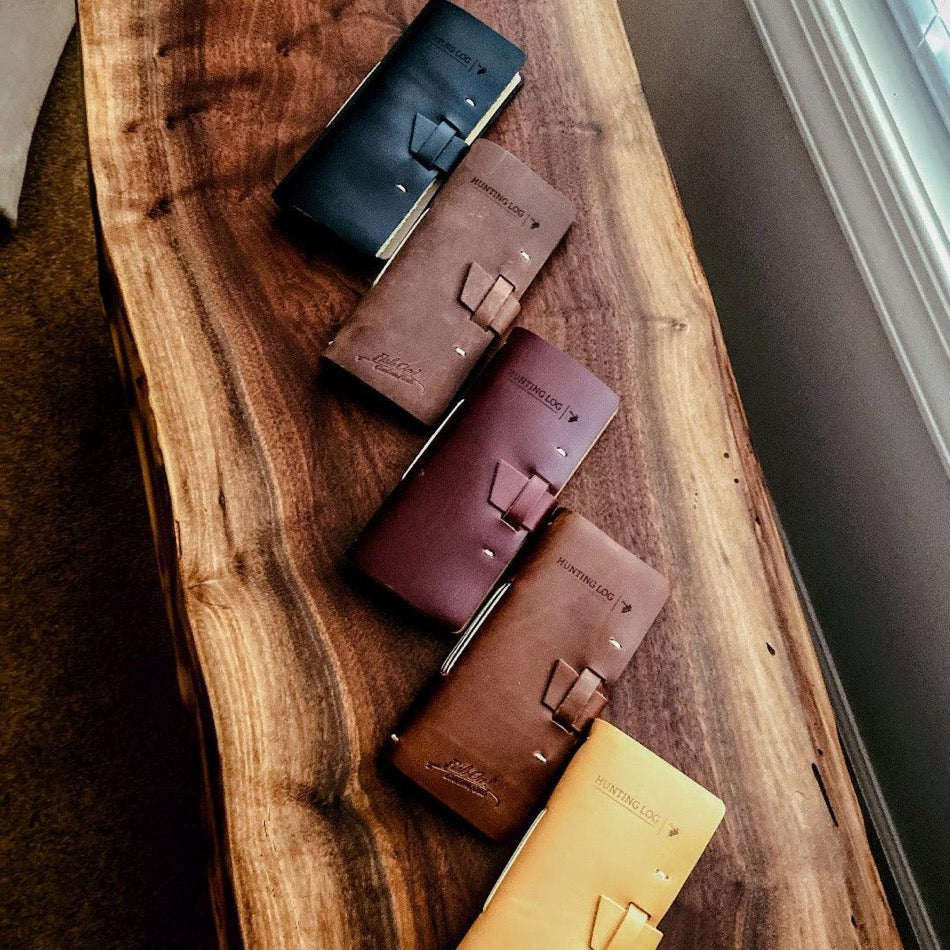 
                  
                    Leather Hunting Journal Early season or better yet preseason or scouting, our Leather Hunting Journal is a great tool for keeping up with key observations, weather conditions, morning or evening and most importantly, your first hunt with your son or daughter.  Designed to be used on any type of hunt, this leather journal is a outdoors enthusiast partner, soon to be filled with memories of a lifetime.   3.75" x 1" x 8" Includes 96 printed rough-cut cream-colored pages
                  
                