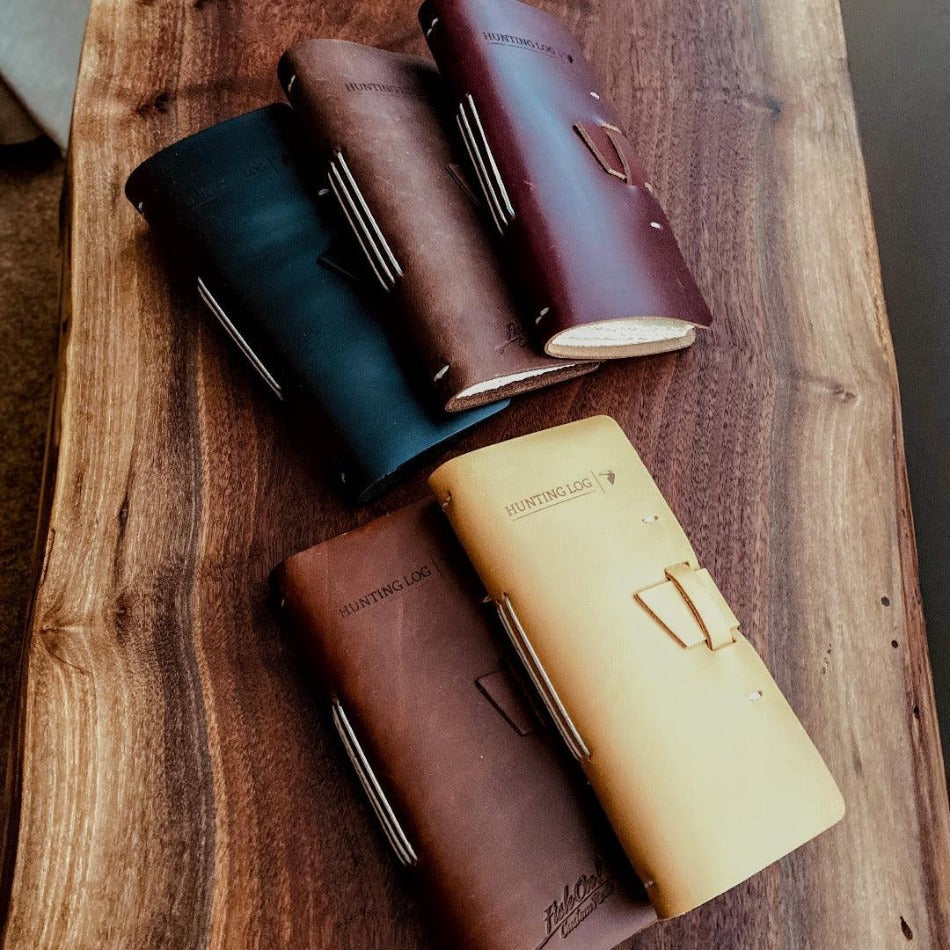 
                  
                    Leather Hunting Journal - Early season or better yet preseason or scouting, our Leather Hunting Journal is a great tool for keeping up with key observations, weather conditions, morning or evening and most importantly, your first hunt with your son or daughter.  Designed to be used on any type of hunt, this leather journal is a outdoors enthusiast partner, soon to be filled with memories of a lifetime.   3.75" x 1" x 8" Includes 96 printed rough-cut cream-colored pages
                  
                