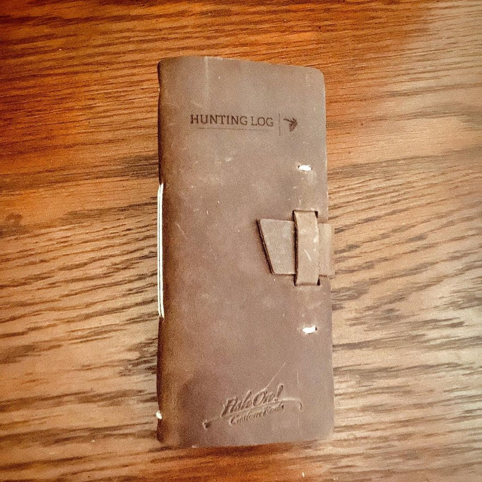 
                  
                    Leather Hunting Journal -Early season or better yet preseason or scouting, our Leather Hunting Journal is a great tool for keeping up with key observations, weather conditions, morning or evening and most importantly, your first hunt with your son or daughter.  Designed to be used on any type of hunt, this leather journal is a outdoors enthusiast partner, soon to be filled with memories of a lifetime.   3.75" x 1" x 8" Includes 96 printed rough-cut cream-colored pages
                  
                