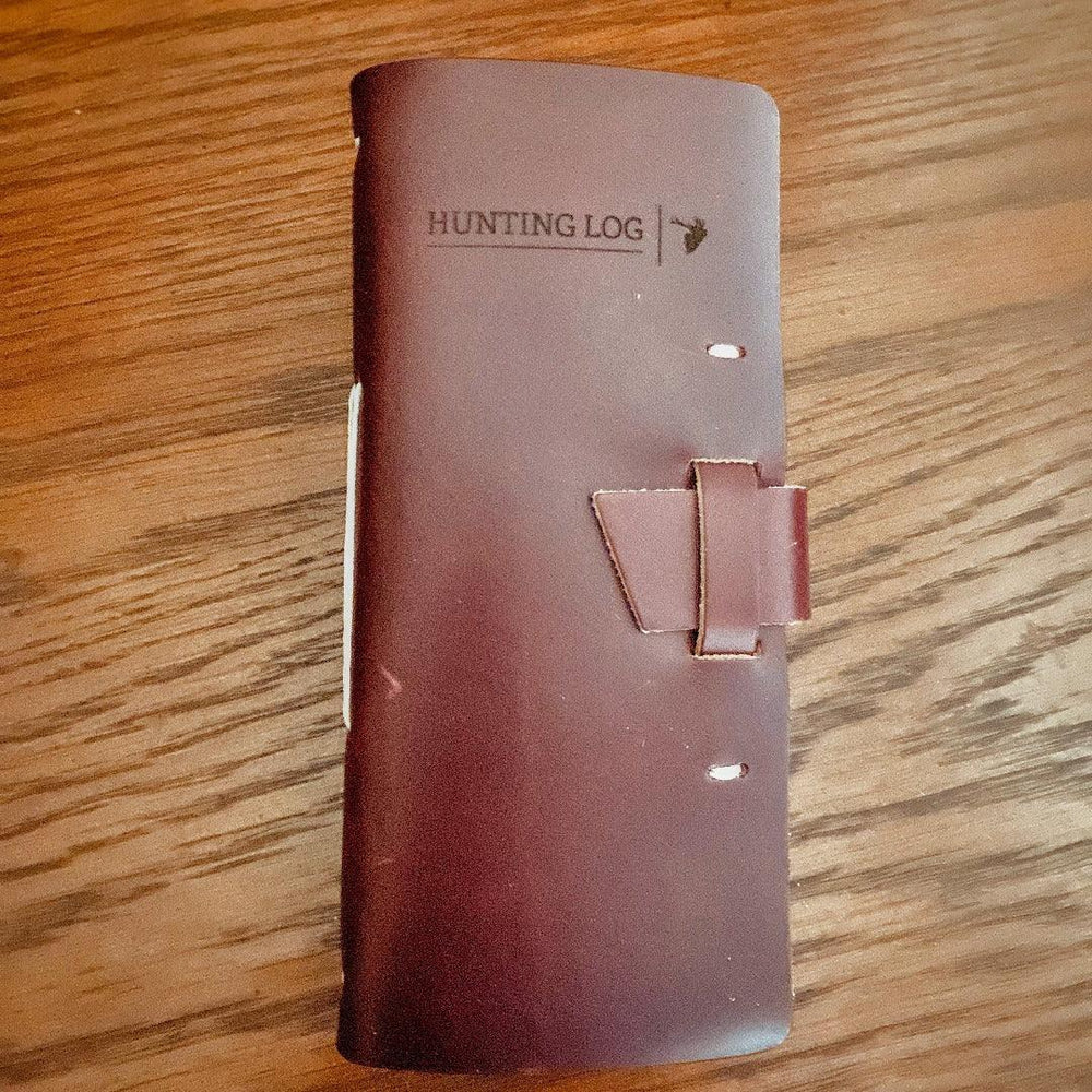 
                  
                    Leather Hunting Journal -Early season or better yet preseason or scouting, our Leather Hunting Journal is a great tool for keeping up with key observations, weather conditions, morning or evening and most importantly, your first hunt with your son or daughter.  Designed to be used on any type of hunt, this leather journal is a outdoors enthusiast partner, soon to be filled with memories of a lifetime.   3.75" x 1" x 8" Includes 96 printed rough-cut cream-colored pages
                  
                