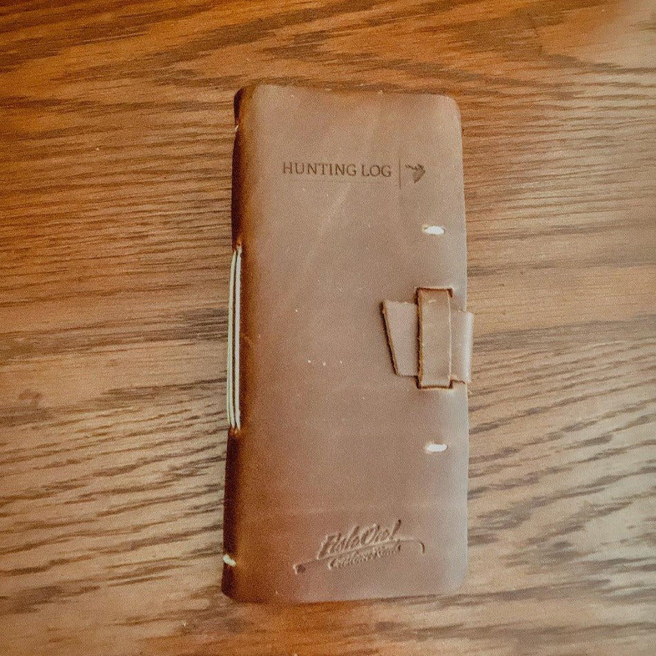 
                  
                    Leather Hunting Journal - Early season or better yet preseason or scouting, our Leather Hunting Journal is a great tool for keeping up with key observations, weather conditions, morning or evening and most importantly, your first hunt with your son or daughter.  Designed to be used on any type of hunt, this leather journal is a outdoors enthusiast partner, soon to be filled with memories of a lifetime.   3.75" x 1" x 8" Includes 96 printed rough-cut cream-colored pages
                  
                