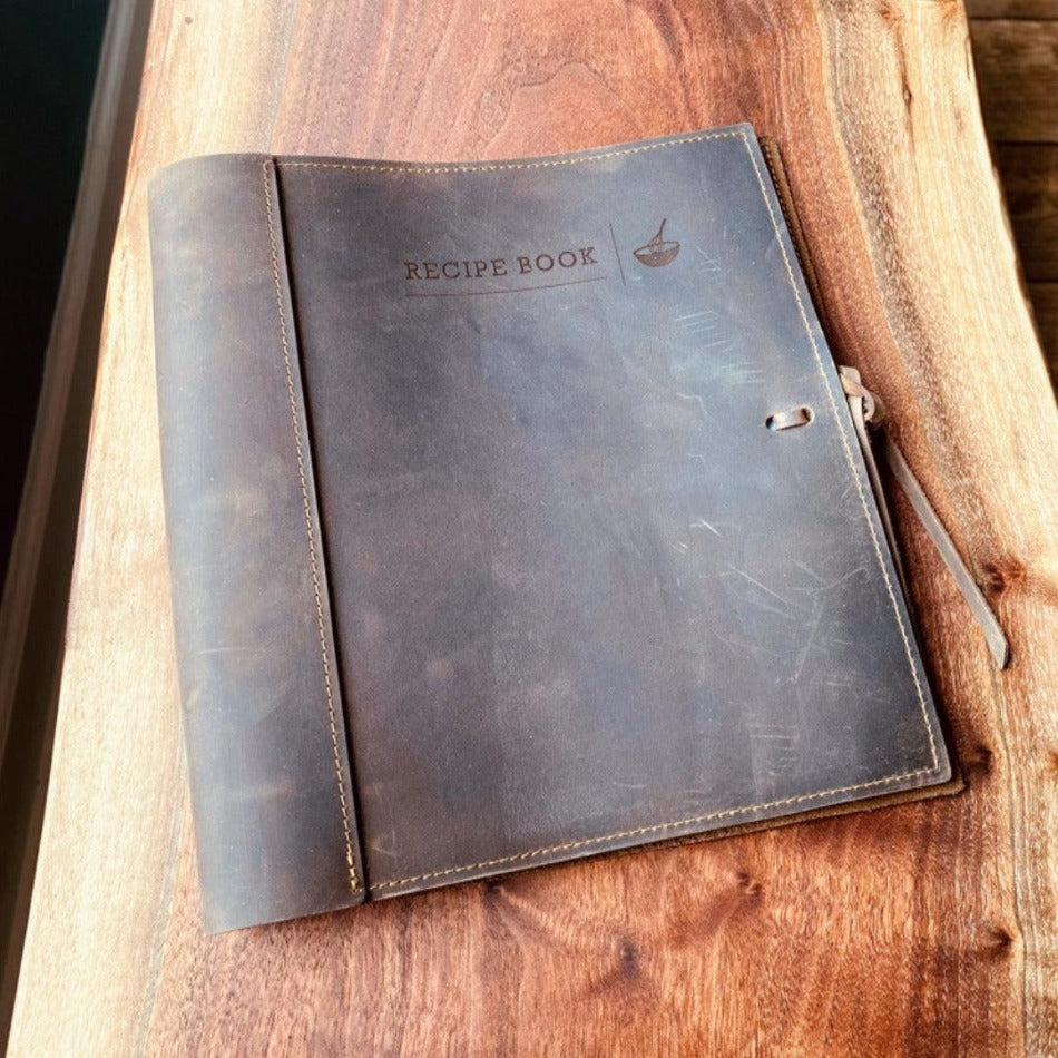 
                  
                    Leather Recipe Binder  This Leather Recipe Binder is a classic way to store all your cherished recipes! Choose from two sizes and get your collection going with plastic page protectors, plus blank 4x6 recipe cards. Keep adding to it for years to come and your recipe book will only get better! It sounds tasty!
                  
                